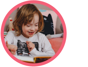 Young boy reading a book and smiling