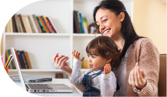 mom and toddler sitting in front of laptop gesturing to the camera